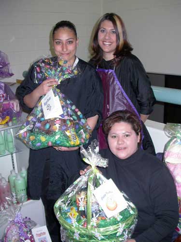 Crysta Avila (standing, left) and Kristen Perea (standing, right), both Cosmetology students, helped with the effort, as did Cosmetology Administrative Assistant Denise Silva.