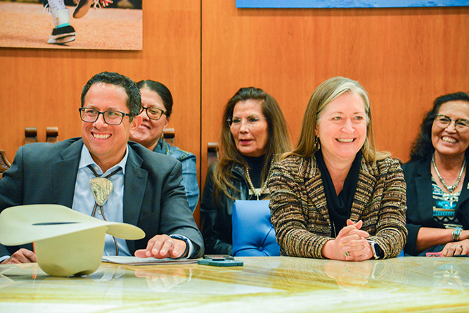 In this Feb. 5, 2025, file photo, UNM-Gallup Local Advisory Board Chairman Raymond Calderon and Chancellor Sabrina Ezzell share a laugh during a roundtable meeting with Gov. Michelle Lujan Grisham at the New Mexico State Capitol in Santa Fe.