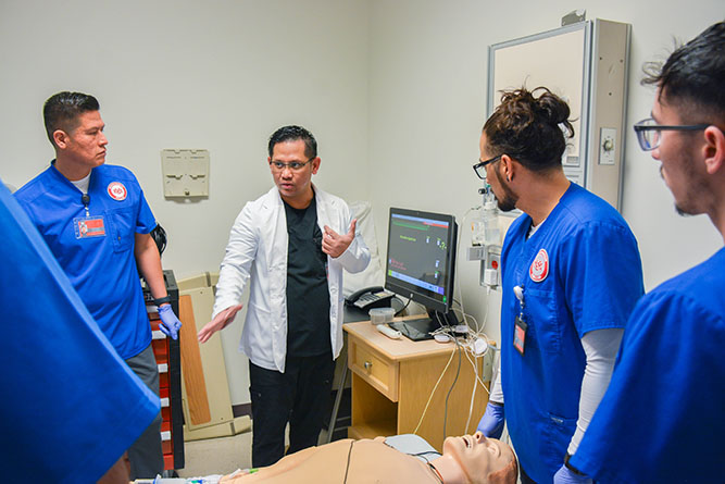 In this February 2025 file photo, UNM-Gallup Assistant Professor Lowell Bautista works with nursing students in the simulation lab of the Nursing Career Center.