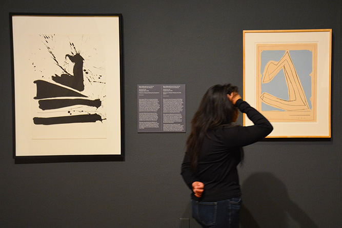 Art Student Collective President Ryanelle Velarde checks out the artwork on display at The University of New Mexico Museum of Art in Albuquerque on April 4, 2025.