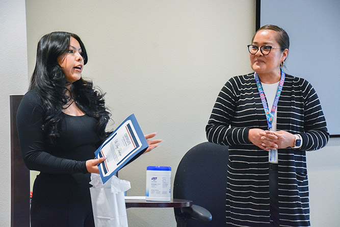 UNM-Gallup alum Amy Anderson talks about her internship experience with the Gallup Police Department while Police Chief Erin Toadlena-Pablo listens during a celebration luncheon on May 6, 2025.