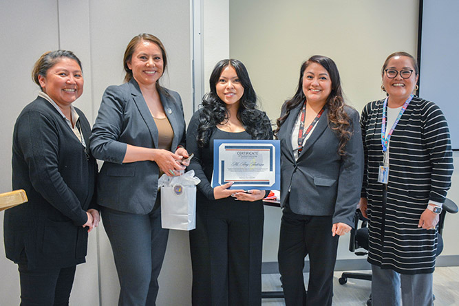 UNM-Gallup alum Amy Anderson, center, poses for a photo with Gallup Police personnel during a celebration luncheon at the police department on May 6, 2025.