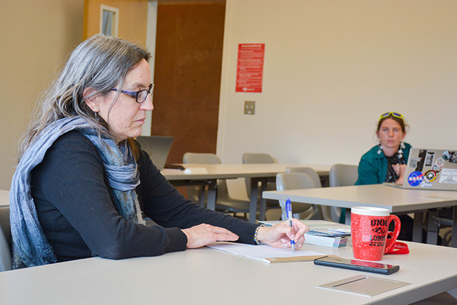 Associate Professor Dr. Tracy Lassiter takes notes during a student presentation in her Professional and Technical Communication class at The University of New Mexico-Gallup on May 6, 2025.