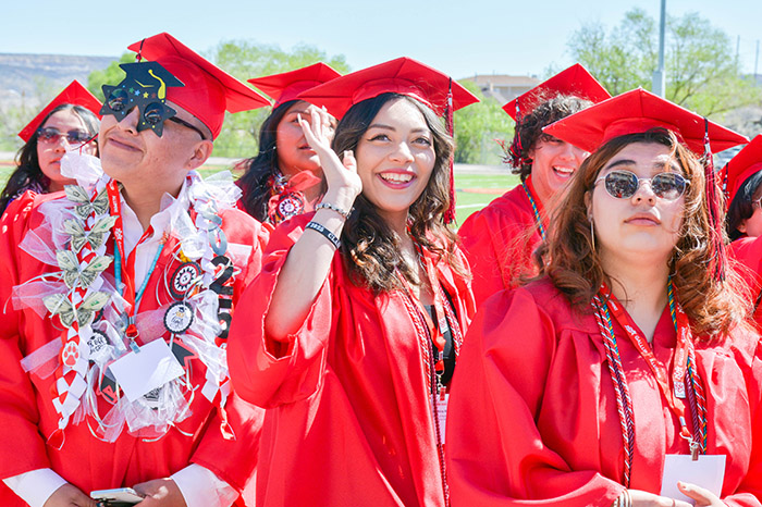 Students in graduation regalia at commencement.