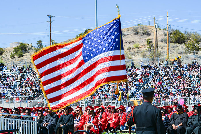 Image of the American flag at a commencement ceremony.