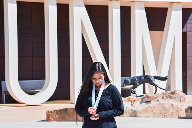 UNM student Layla Perry adjusts her SkillsUSA medal before posing for a portrait at The University of New Mexico-Gallup campus on July 11, 2025.