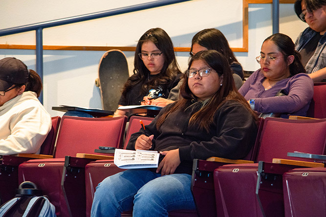 Gallup High School student Taylor Benny, interning as a public relations assistant for The University of New Mexico-Gallup, takes notes during Dr. Nancy J. Hamilton's lecture in the Calvin Hall Center Auditorium on Wednesday, March 25, 2026. Photo by Richard Reyes/UNM-Gallup.