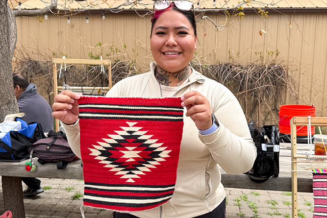 UNM-Gallup student Nakeisha Begaye shows her first completed weaving project in downtown Gallup on Friday, April 10, 2026. 