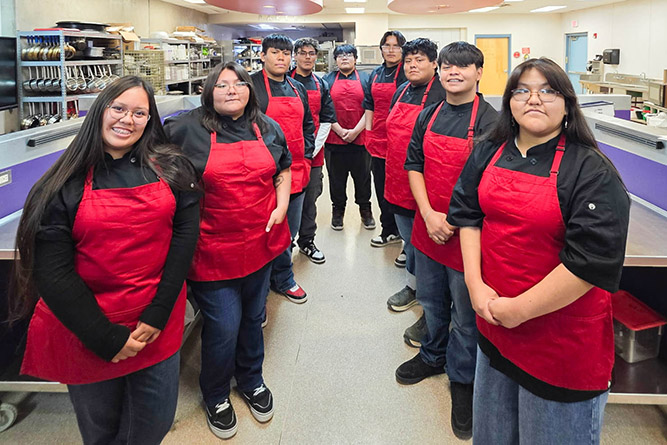 UNM-Gallup Center for Career and Technical Education culinary students pose for a photo inside the kitchen at Miyamura High School. From left: Lila Lee, Autumn Jim, Malika Jones, Lyfe Yazzie,, Kenyon Begay, Landon Tyler, Raymond Smith, Cameron Yazzie, and Hazel Antonio.