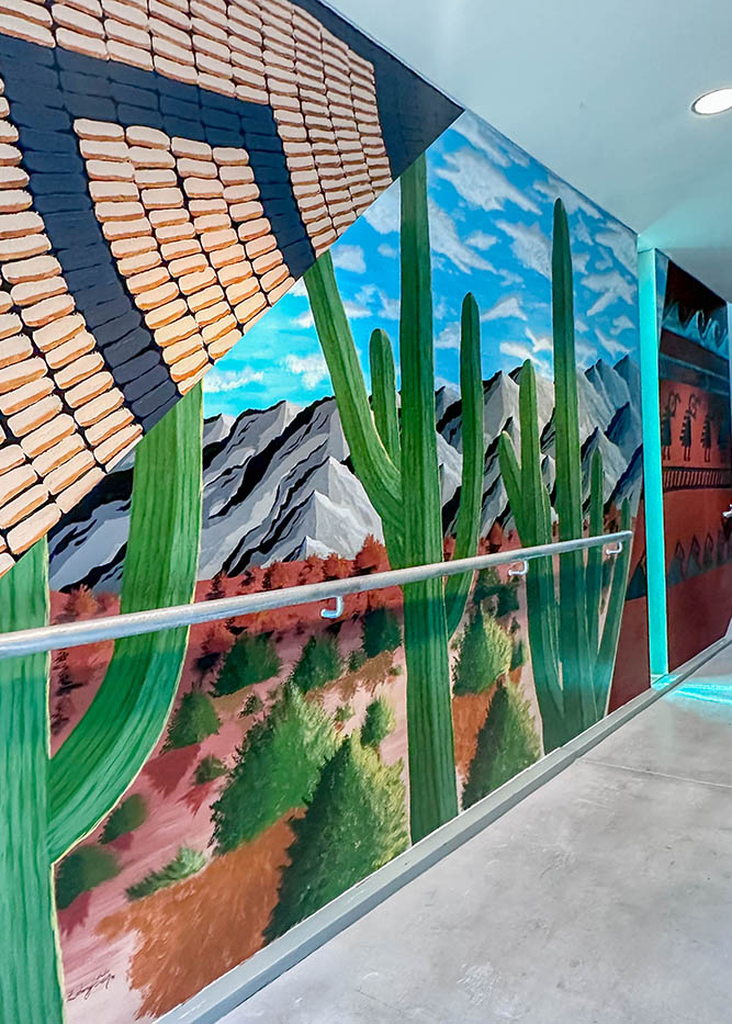 A landscape mural features mountains, cacti and a glimpse of a basket design at the Huhugam Heritage Center in Chandler, Arizona, on Friday, March 6, 2026.