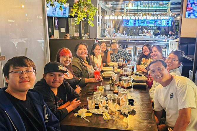 7.	From left: Luke Haley, Cory Herbert, Julia Simms, Shynowah Bahe, Katelynn Wilson, Jaelyn Dakia, Micah Gruber, Alicia Morris, Kristina Acothley, Ashley Thomas, and Todd Armitstead pose for a group photo at Lolo’s Chicken & Waffles in Phoenix on Saturday, March 7, 2026.