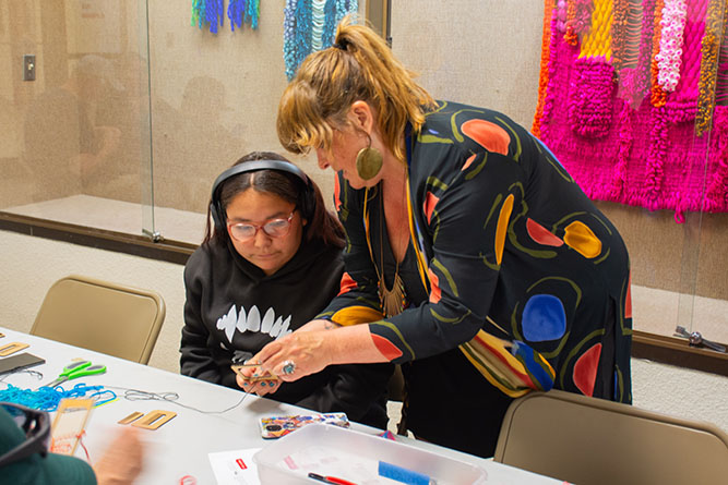 Santa Fe fiber artist Leigh Oviatt assists Keira Peterson during a fiber workshop outside the Ingham Chapman Gallery at The University of New Mexico-Gallup on March 26, 2026.