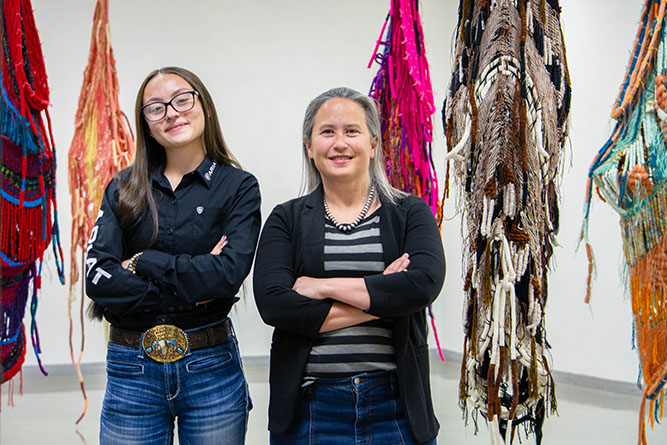Work-study student employee Jimi Christian, left, and Gallery Manager Dana Aldis pose for a portrait inside the Ingham Chapman Gallery at The University of New Mexico-Gallup on March 18, 2026.