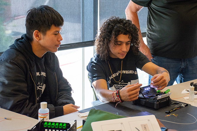 7. Students Sonnie Sam, left, and Uriah Hardin work on a fusion splicing exercise during the Fiber Optic Bootcamp at The University of New Mexico-Gallup on Friday, June 12, 2026.