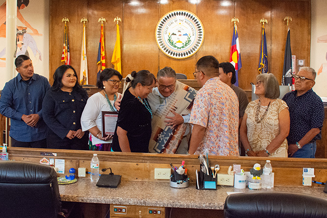 Navajo Nation Council Speaker Crystalyne Curley and UNM-Gallup Interim Dean of Instruction Joe Kee hug after a recognition ceremony in the Navajo Nation Council Chambers in Window Rock, Arizona, on Wednesday, July 22, 2026.