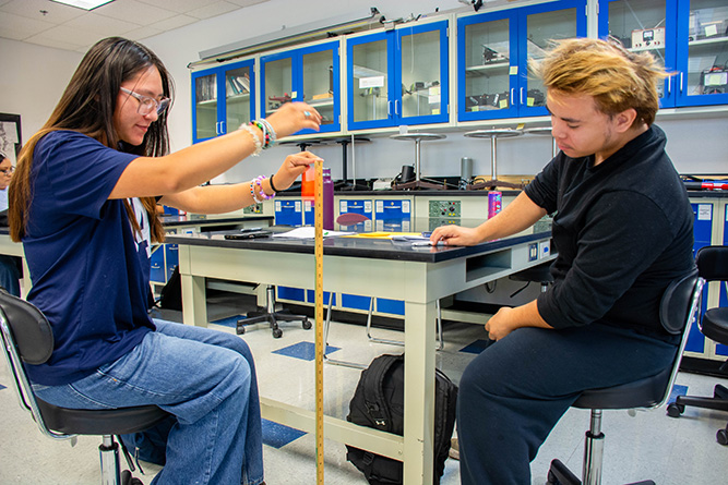 Students Harmony Manuelito, left, and Isaiah Ronald Fuller observe and measure the bounce height of a ball during an environmental science lab titled The Blue Planet in Calvin Hall Center at The University of New Mexico-Gallup on Wednesday, Aug. 19.