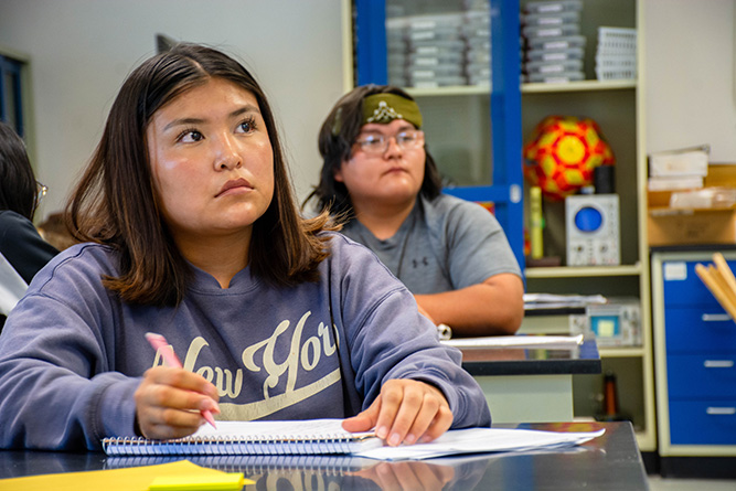 Students McKenzie Tsosie, left, and Tristin Toledo take notes in an environmental science class titled The Blue Planet in Calvin Hall Center at The University of New Mexico-Gallup on Wednesday, Aug. 19.