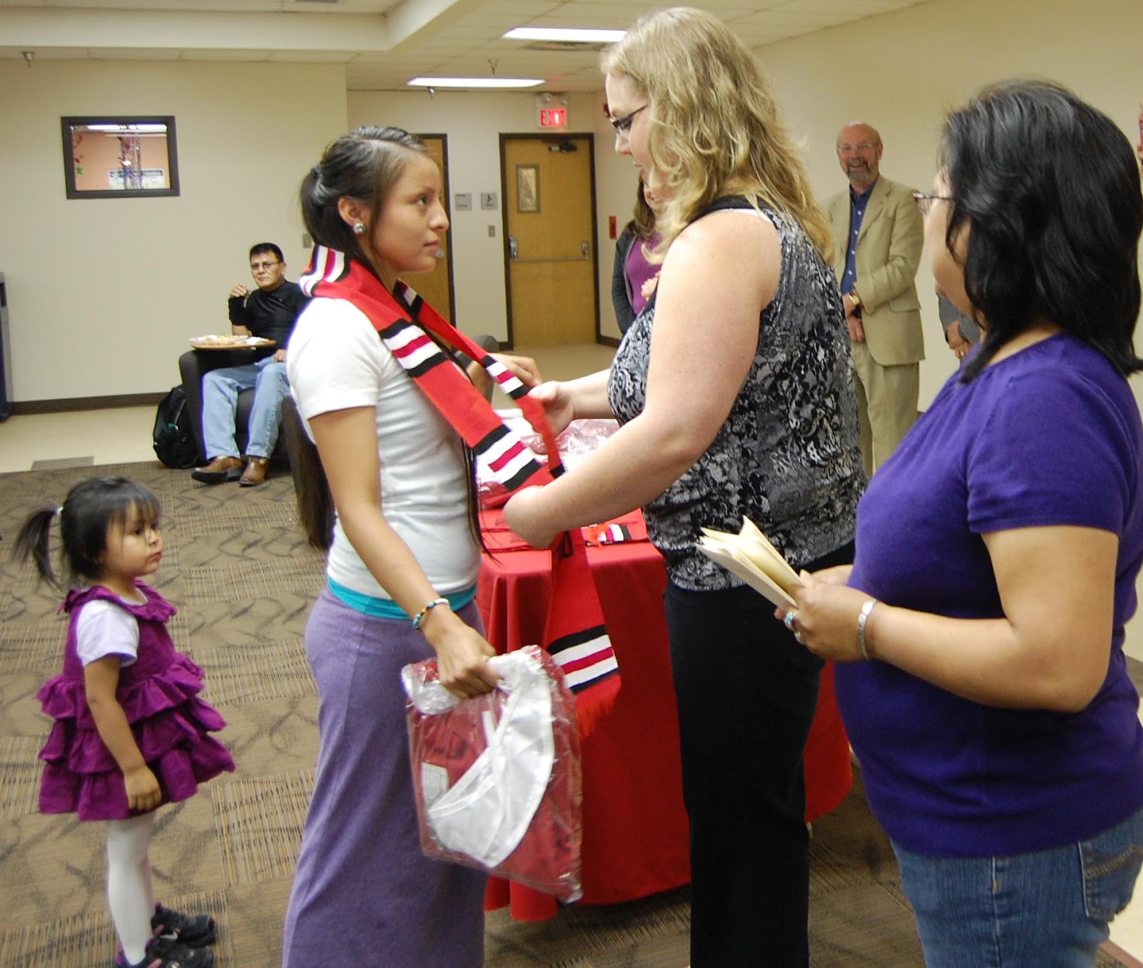 Leah Kayonnie receives a TRiO stole from TRiO Program Manager Jayme McMahon.