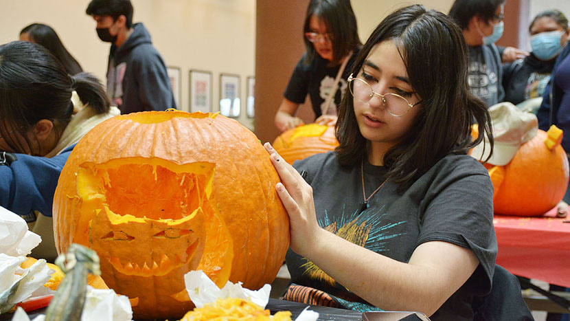 UNM-Gallup students, staff and faculty celebrate Halloween with pumpkin carving, history lecture and costume contest